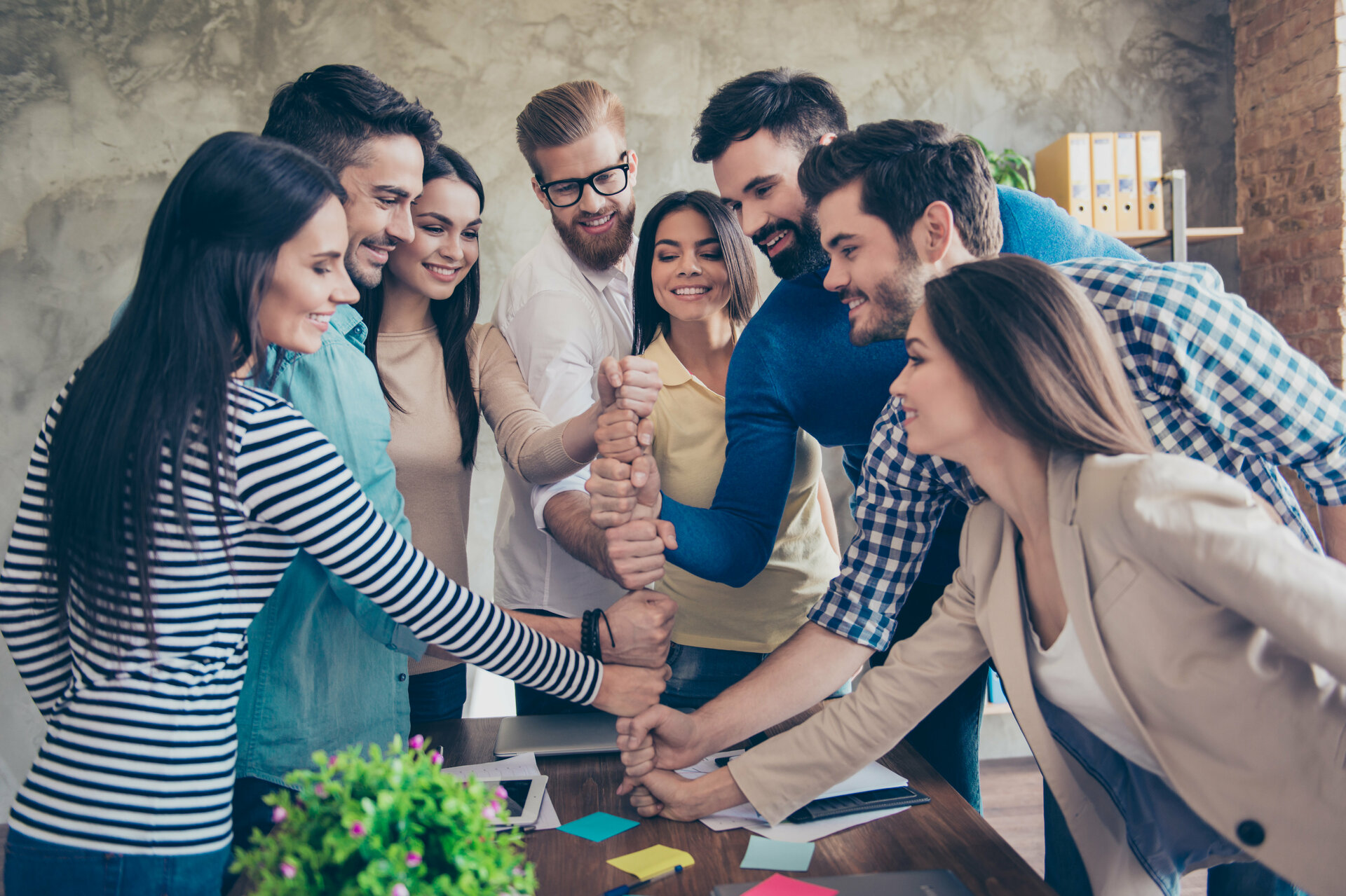 Eine Gruppe von Menschen, die ihre Fäuste übereinanderlegen